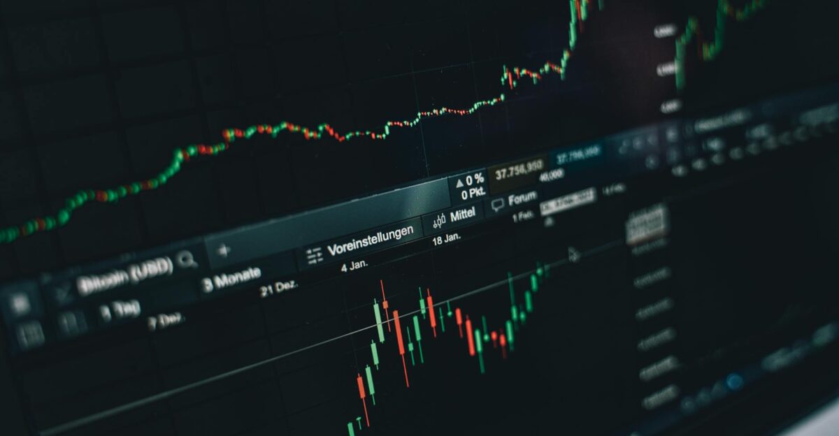Close-up of a digital market analysis display showing Bitcoin and cryptocurrency price trends