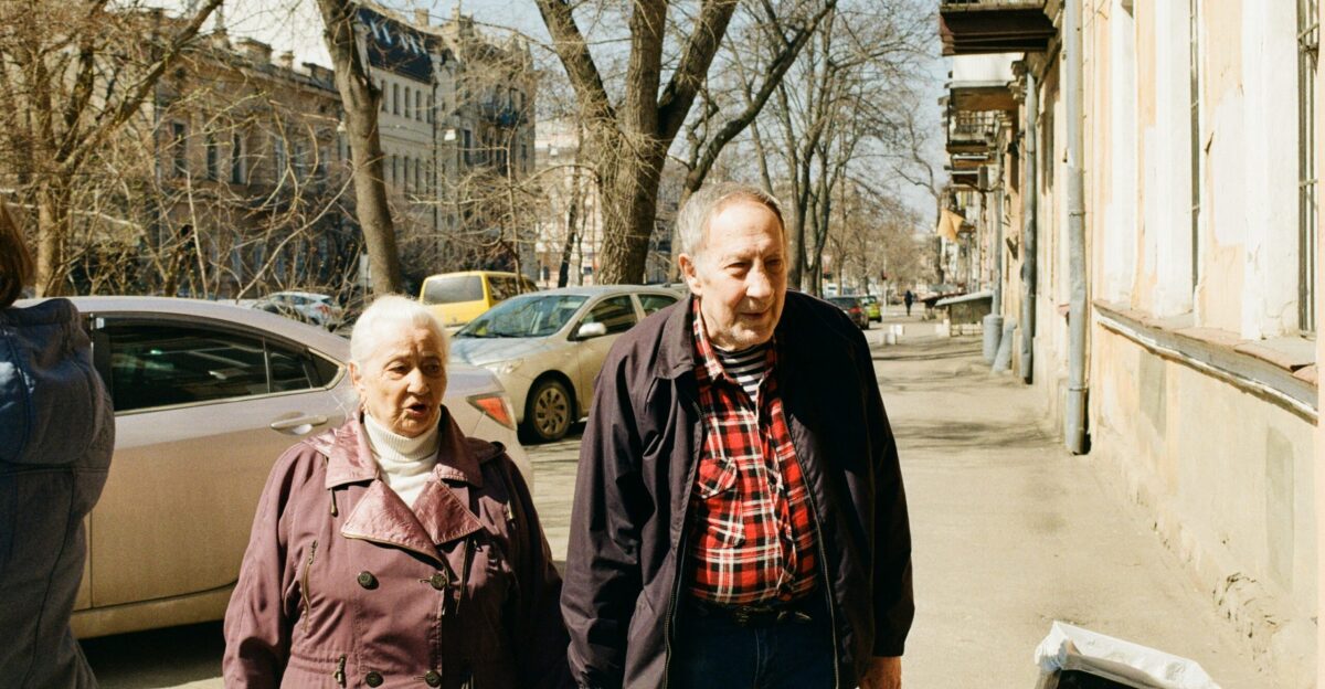 a group of people standing on a sidewalk