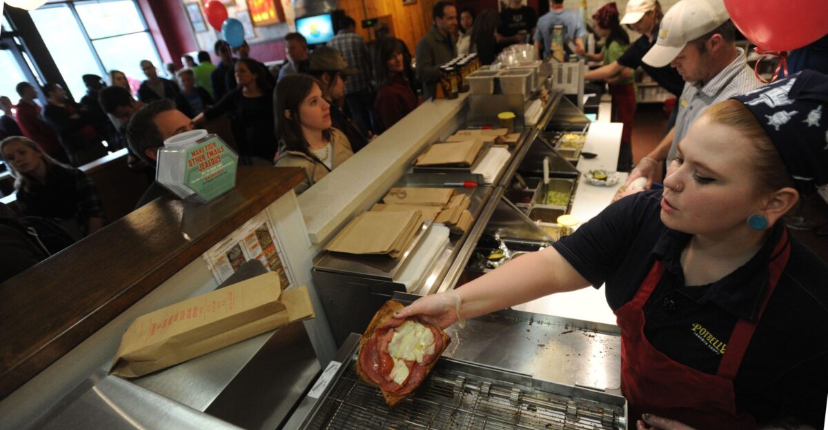 Potbelly Sandwich Shop employees Kate Kleinheider and Lance O Hara serve customers during the restaurant s opening day on Tuesday in Campustown Potbelly known for its toasted sandwiches signature shakes and live music has more than 300 shops across the country but the Ames location is its first in Iowa Photo by Nirmalendu Majumdar Ames Tribune by Ames Tribune