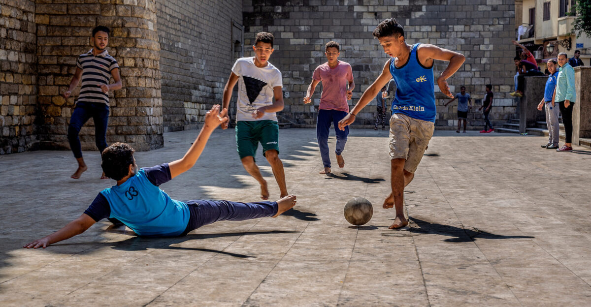 Children playing street football in Egypt one of the most famous games in Africa Location Al-Mu izz Street at the exterior of Al-Hakim mosque - Camera location30 03 17 49 N 31 15 47 37 E View this and other nearby images on OpenStreetMap 30 054859 31 263158