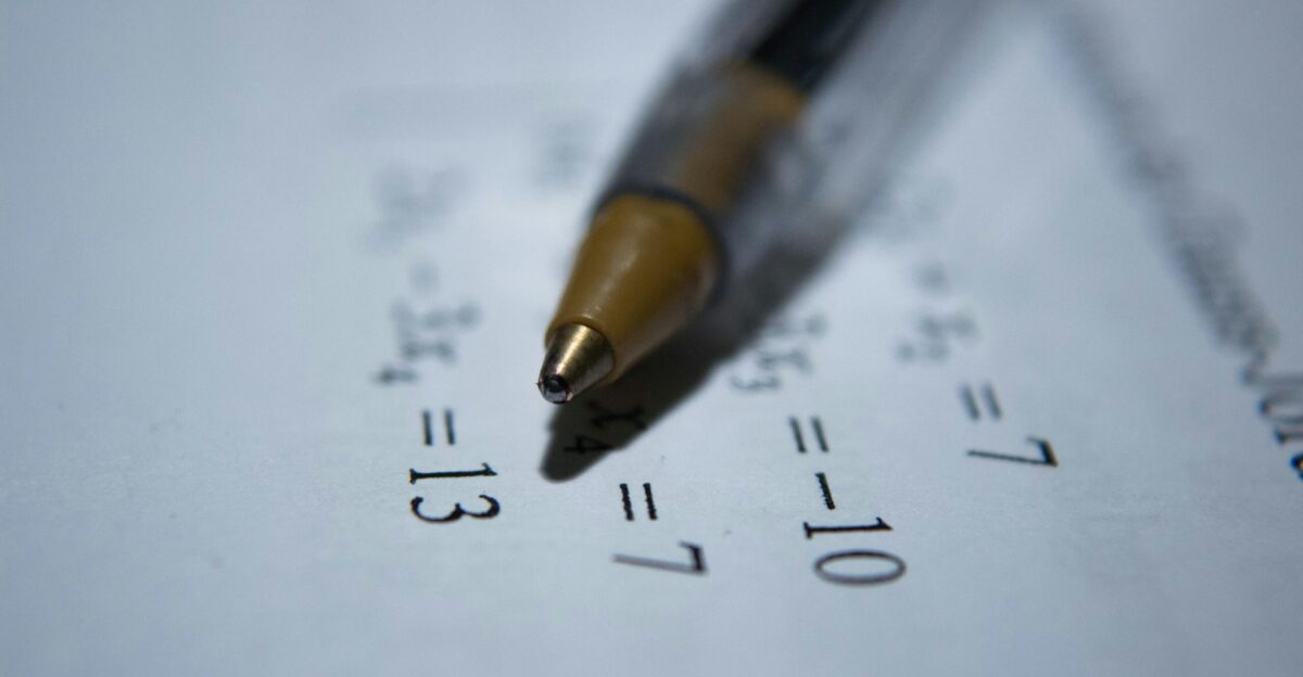 black retractable pen on white printer paper