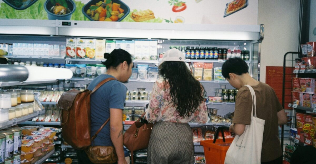 woman in brown long sleeve shirt and gray pants standing in front of white counter