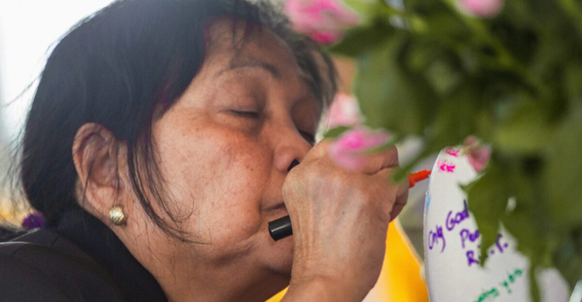 a person smelling a flower