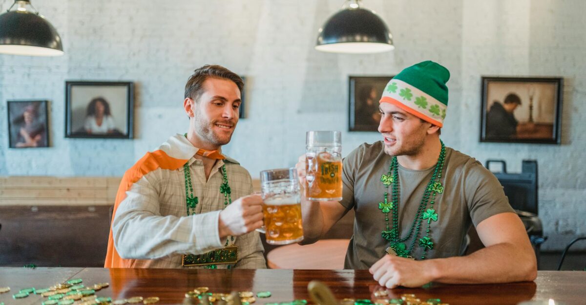 Two men celebrating St Patrick s Day with a beer toast in a pub setting