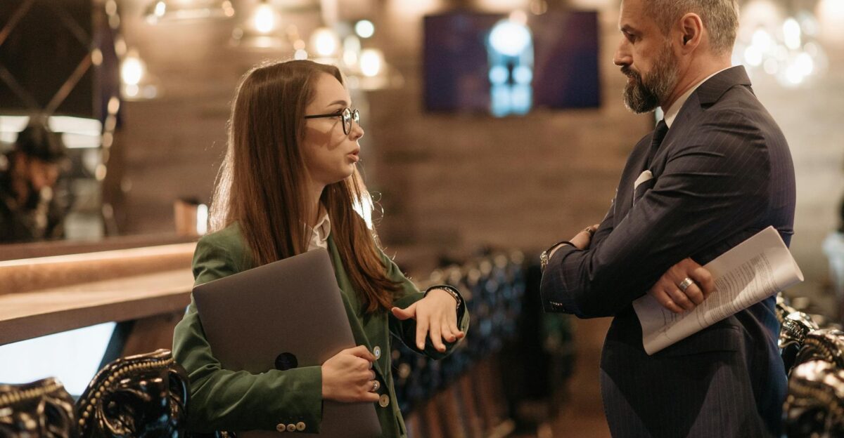 Two business professionals engaging in conversation in a stylish bar interior highlighting modern work culture