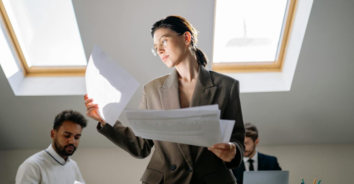 Professional team reviewing documents under natural light in a modern office