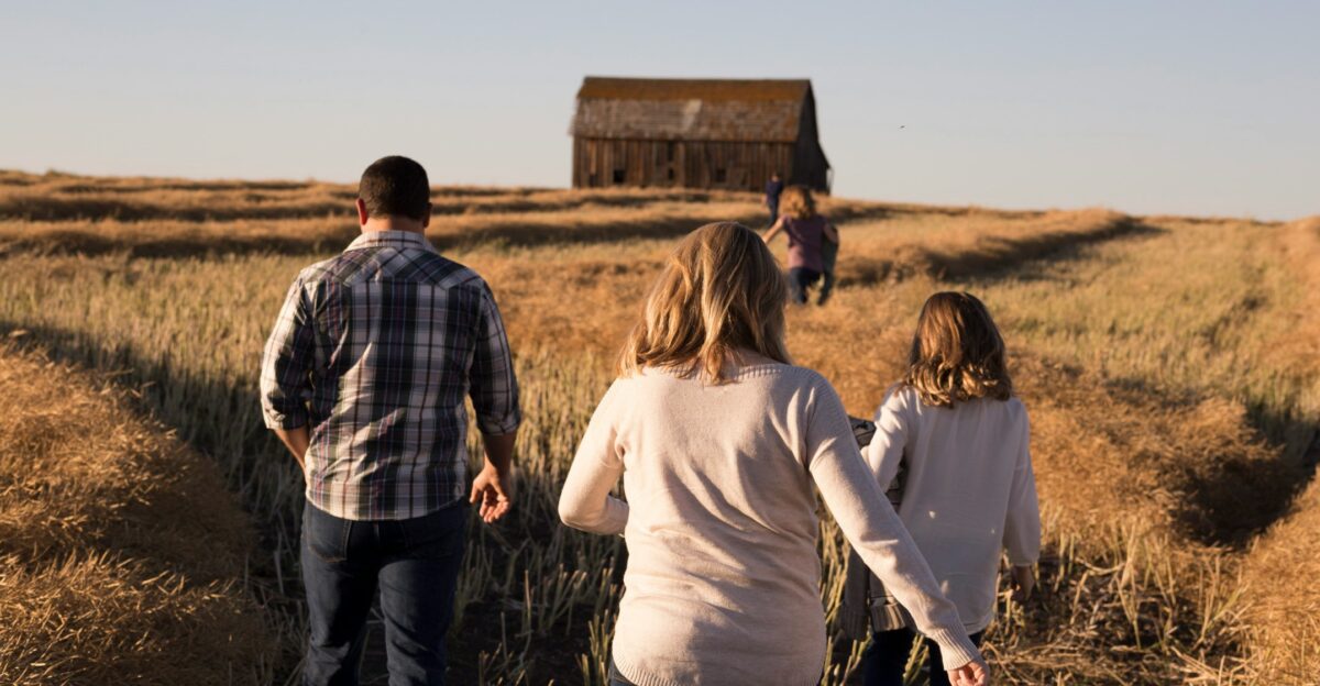 man and women walks on grasses during daytime