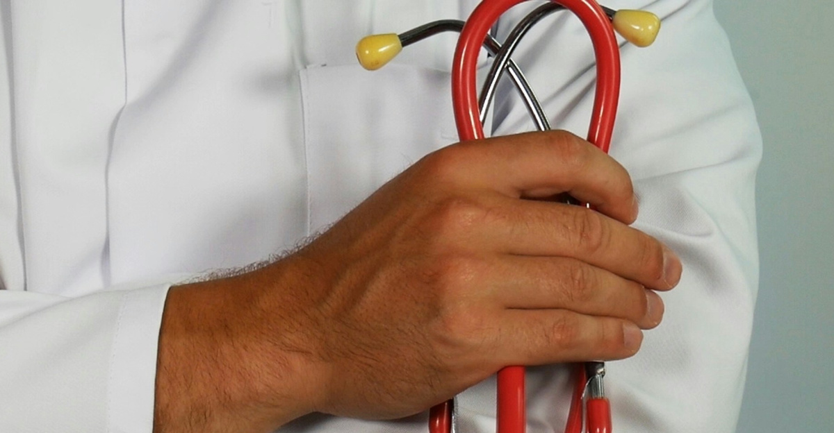 doctor holding red stethoscope
