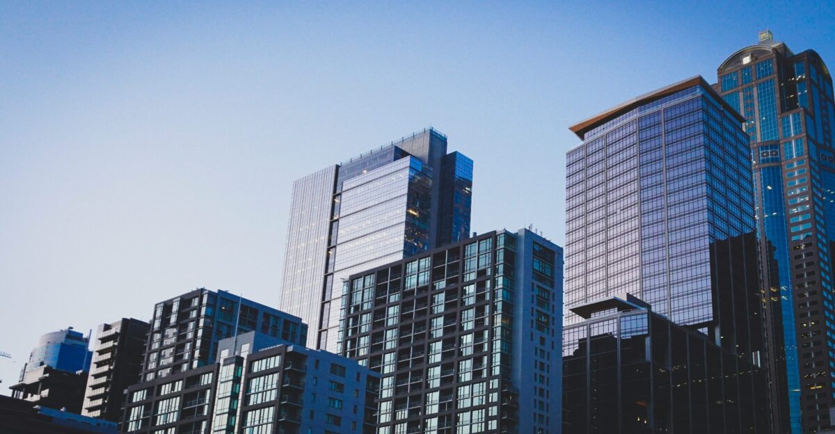 white and blue glass walled high rise building
