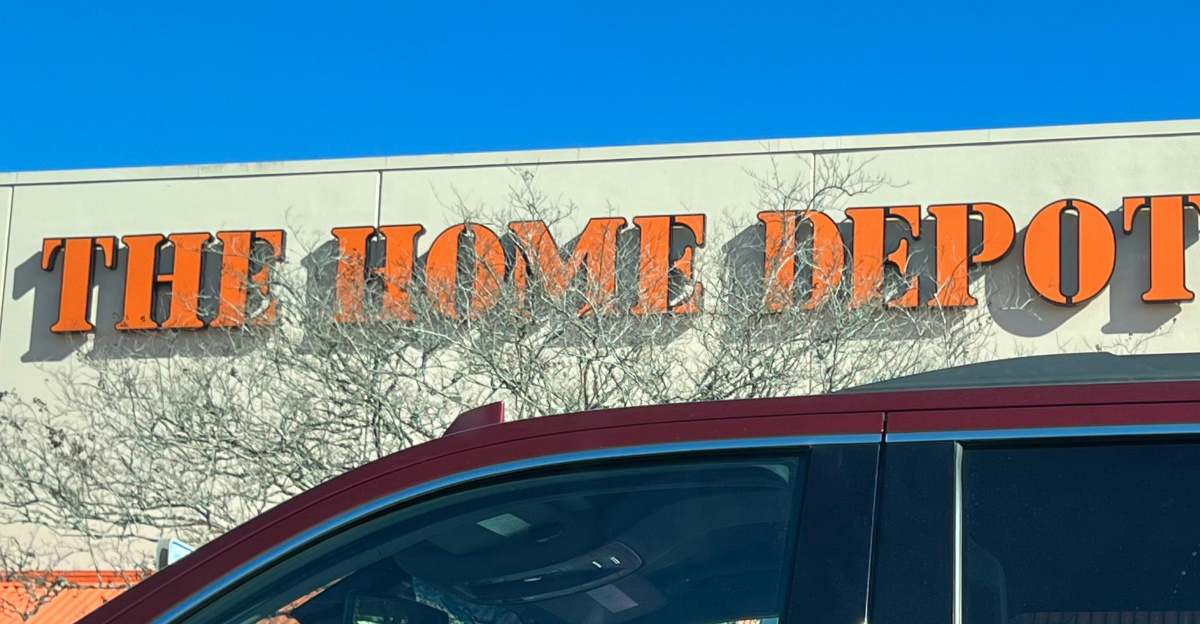 a red car parked in front of a home depot