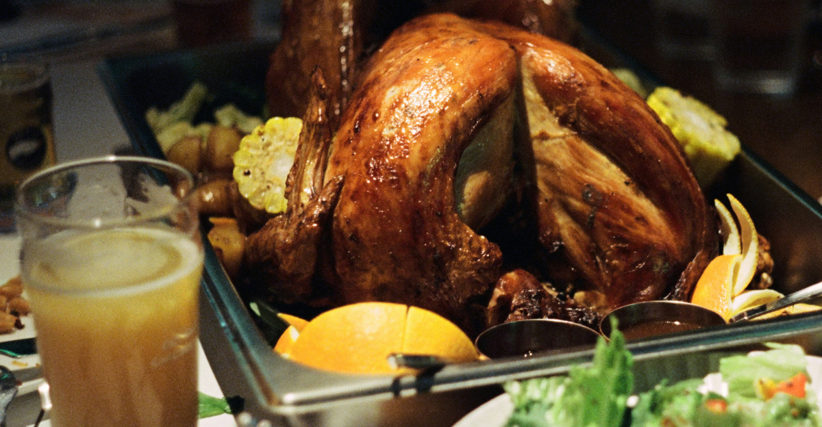 A table filled with plates of food and a turkey