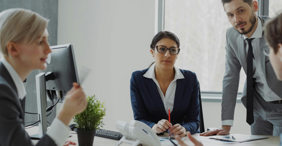 Business professionals collaborating in a modern office meeting.