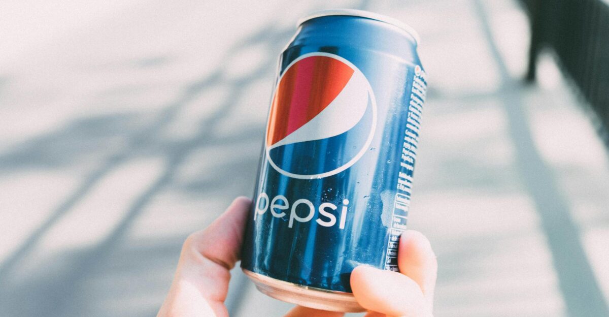 Refreshing Pepsi can held in hand on a sunny day Perfect for advertisements