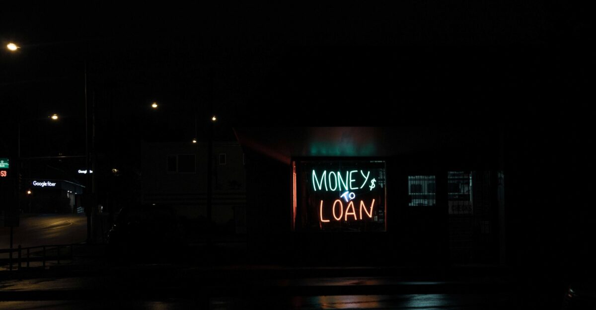 a neon sign is lit up in the dark