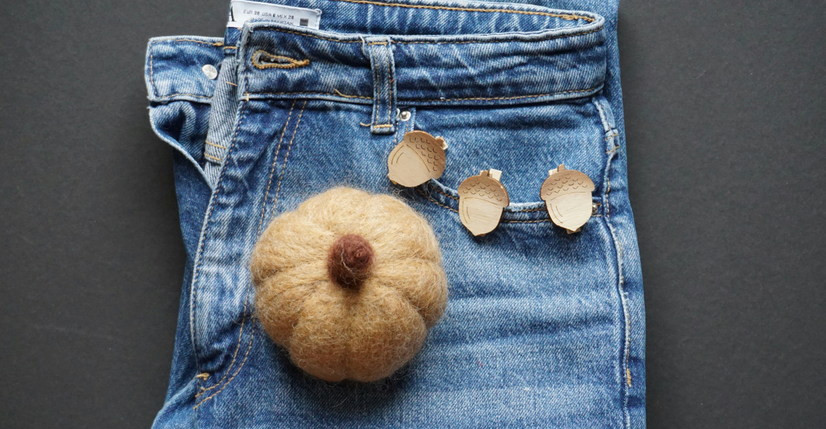 a pair of jeans with a stuffed bear on the front