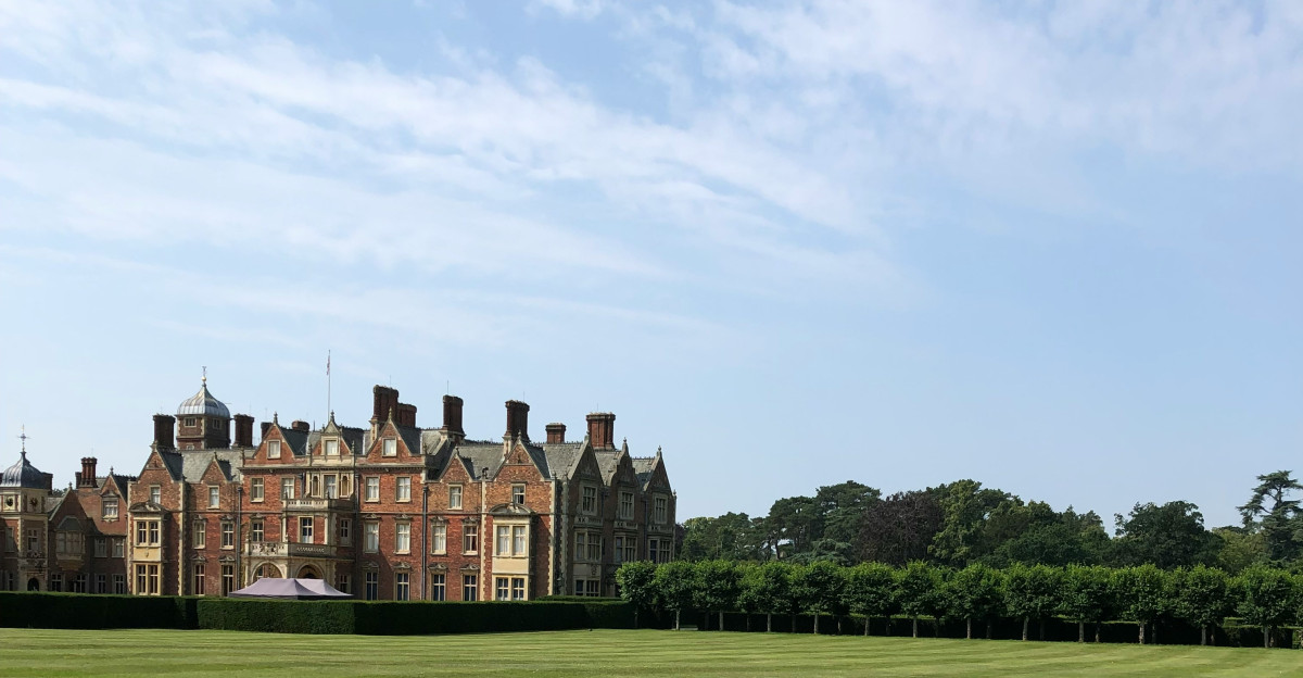 a large building with a lawn in front of it